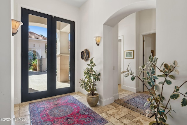236 Deer Haven Dr, Ponte Vedra Beach, FL 32082 - foyer featuring arched walkways, french doors, and stone tile flooring