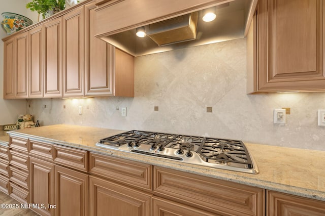 236 Deer Haven Dr, Ponte Vedra Beach, FL 32082 - kitchen featuring stainless steel gas cooktop, tasteful backsplash, custom exhaust hood, and light stone countertops