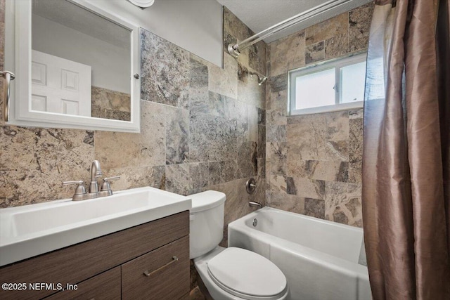 full bathroom with shower / tub combo, tile walls, vanity, and toilet