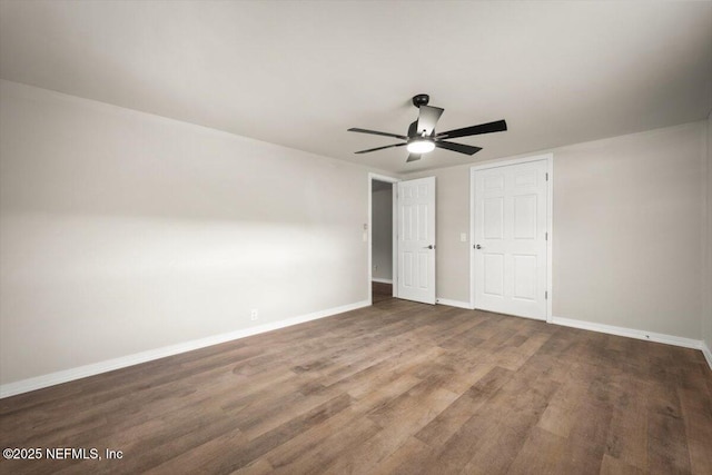 unfurnished bedroom with a ceiling fan, baseboards, and wood finished floors