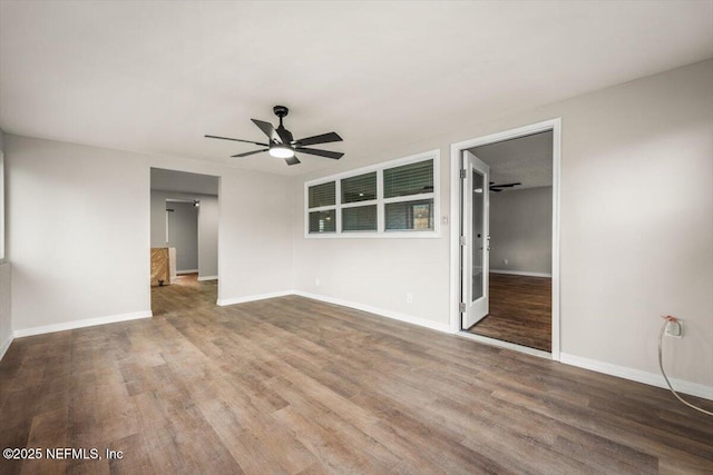 unfurnished bedroom featuring a ceiling fan, baseboards, and wood finished floors