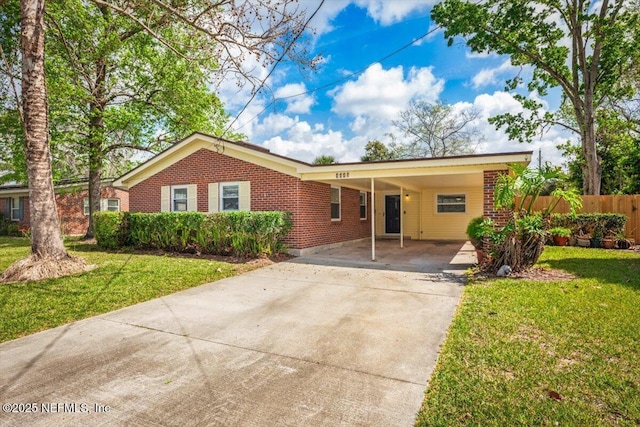 ranch-style house with driveway, fence, a front lawn, and brick siding