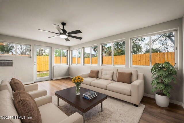 sunroom / solarium featuring ceiling fan and a wealth of natural light