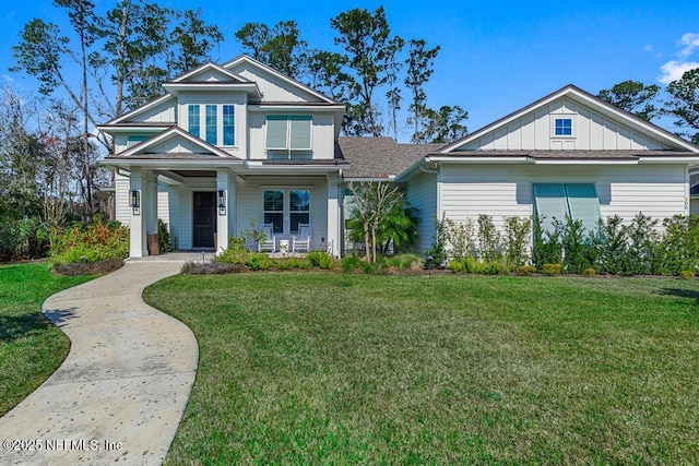 craftsman inspired home featuring a porch, board and batten siding, and a front yard