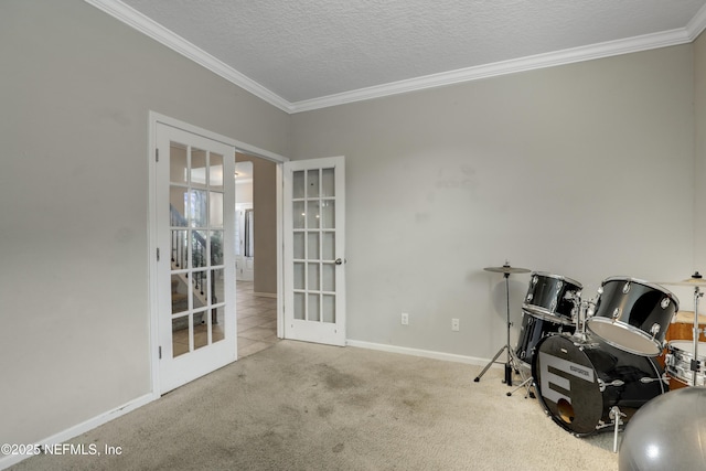 miscellaneous room featuring carpet, baseboards, french doors, a textured ceiling, and crown molding