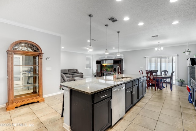 kitchen featuring visible vents, dishwasher, crown molding, and a sink
