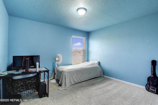 carpeted bedroom featuring baseboards and a textured ceiling