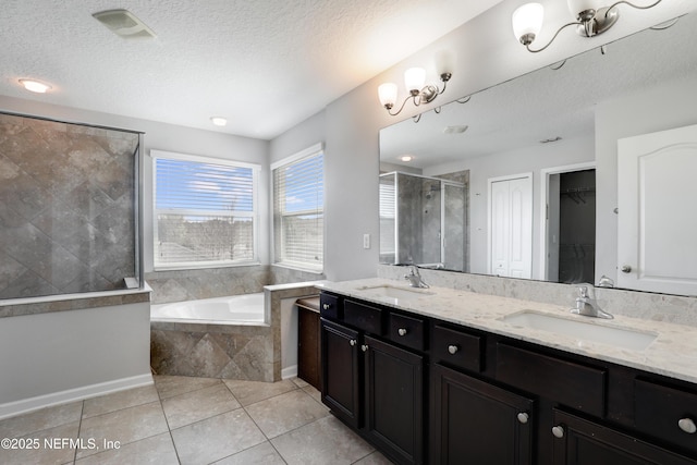 bathroom featuring a sink, a stall shower, tile patterned flooring, and a bath
