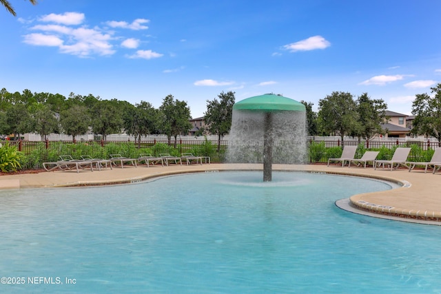 view of swimming pool with a patio area and fence