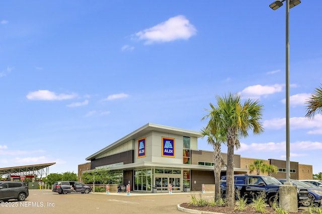 view of property featuring uncovered parking