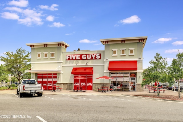 view of building exterior with uncovered parking
