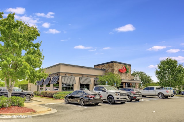 view of building exterior featuring uncovered parking