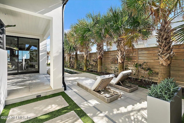 view of patio / terrace featuring fence