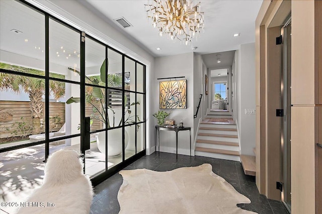 interior space featuring baseboards, stairs, visible vents, and a chandelier