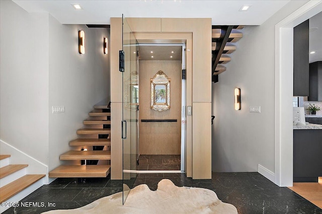 interior space with recessed lighting and elevator