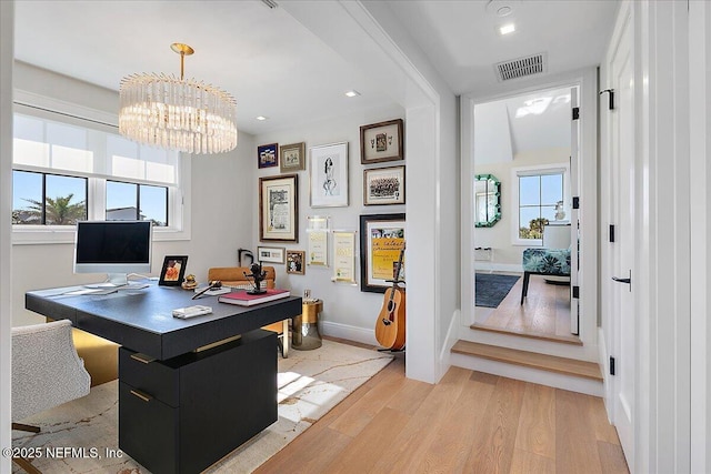 office space with a chandelier, light wood-style flooring, recessed lighting, visible vents, and baseboards