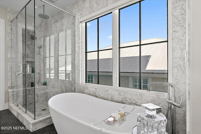 bathroom featuring a freestanding tub and a shower stall