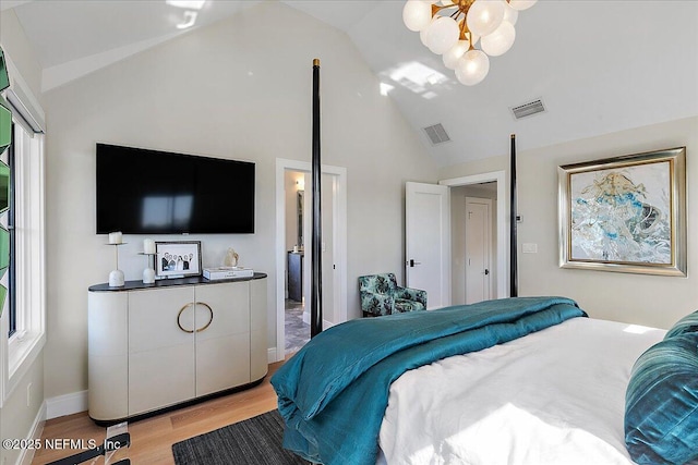 bedroom with light wood-type flooring, visible vents, vaulted ceiling, and a notable chandelier