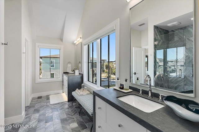 bathroom featuring a stall shower, visible vents, baseboards, and vanity