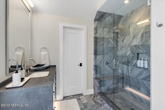 full bathroom with a shower stall and vanity