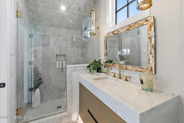 full bathroom with a shower stall and vanity