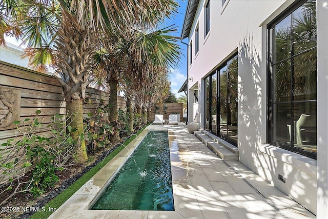 view of patio featuring a fenced in pool and a fenced backyard