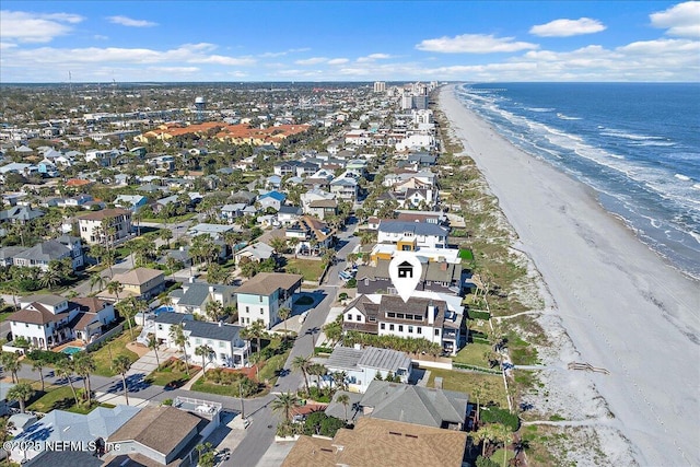 birds eye view of property featuring a water view, a residential view, and a view of the beach