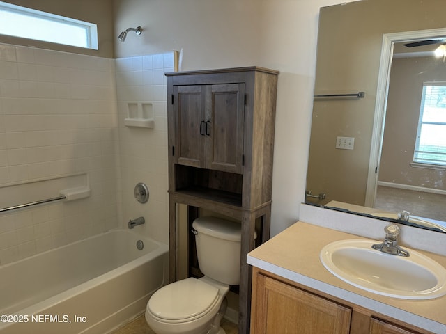 bathroom featuring toilet, shower / bathing tub combination, and vanity