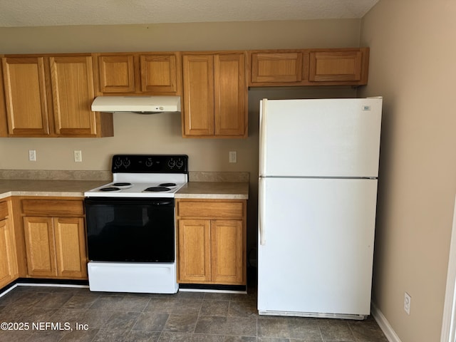 kitchen with freestanding refrigerator, electric stove, light countertops, and under cabinet range hood