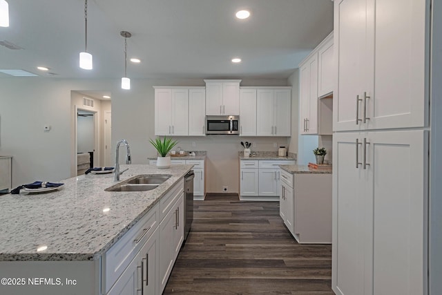 kitchen with stainless steel appliances, white cabinets, dark wood-type flooring, and a sink