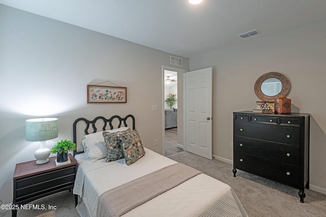 bedroom featuring light carpet, visible vents, and baseboards