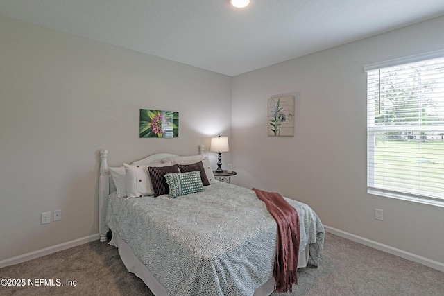 carpeted bedroom featuring baseboards