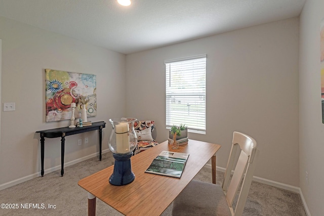 dining area with light carpet and baseboards