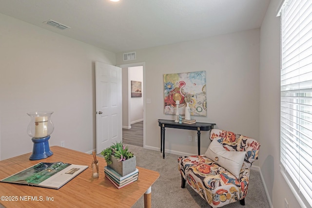 living area featuring carpet, visible vents, and baseboards