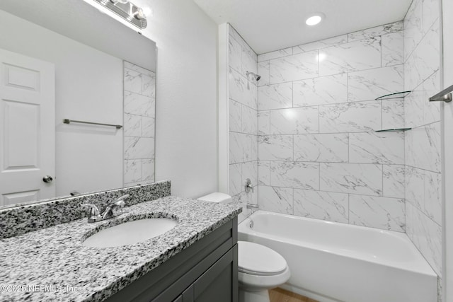 bathroom featuring shower / bath combination, vanity, and toilet