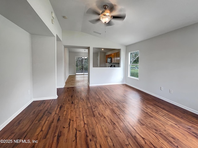 unfurnished room with ceiling fan, lofted ceiling, visible vents, baseboards, and dark wood finished floors