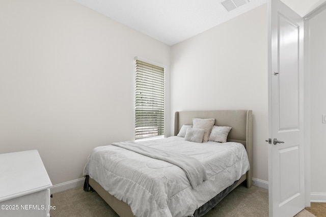 bedroom featuring light carpet, baseboards, and visible vents