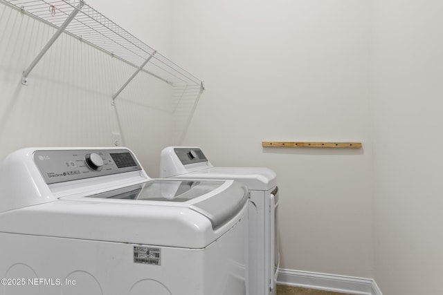 laundry room with laundry area, independent washer and dryer, and baseboards