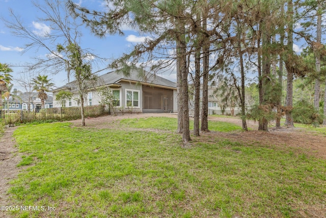 view of yard with a sunroom and fence