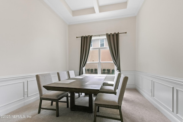 dining area with coffered ceiling, light colored carpet, a wainscoted wall, a decorative wall, and beam ceiling