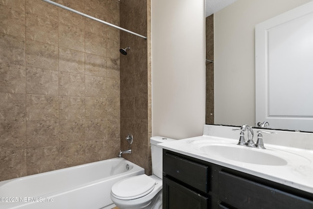 bathroom featuring bathtub / shower combination, vanity, and toilet