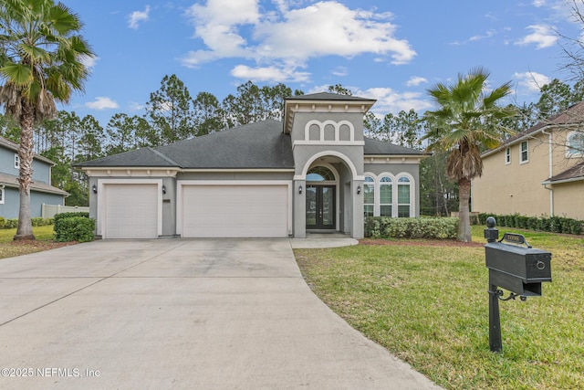 mediterranean / spanish-style house featuring concrete driveway, an attached garage, french doors, a front yard, and stucco siding