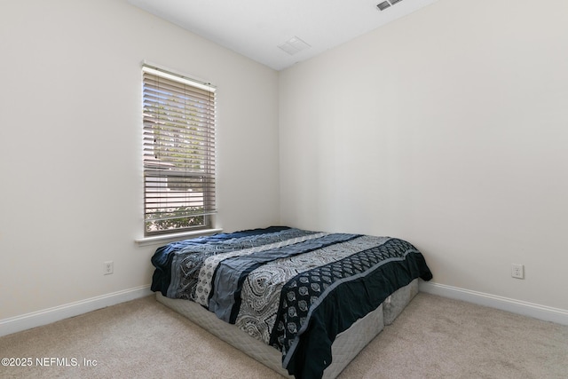 bedroom with carpet floors, visible vents, and baseboards