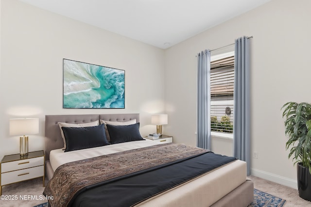 carpeted bedroom featuring baseboards