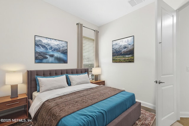 bedroom with visible vents and baseboards