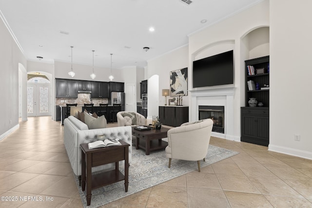 living room featuring crown molding and light tile patterned flooring