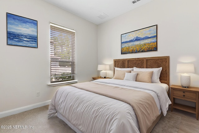 bedroom featuring visible vents and baseboards