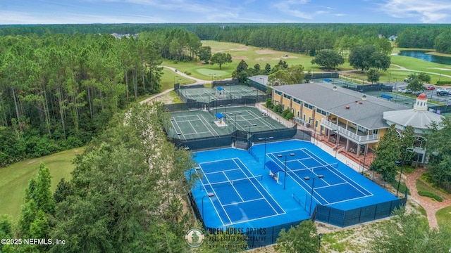 birds eye view of property with a water view, golf course view, and a view of trees