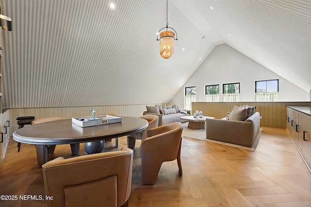 living area with lofted ceiling and wood walls