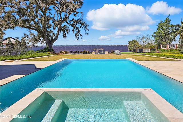 view of pool with a yard, a patio area, and a pool with connected hot tub